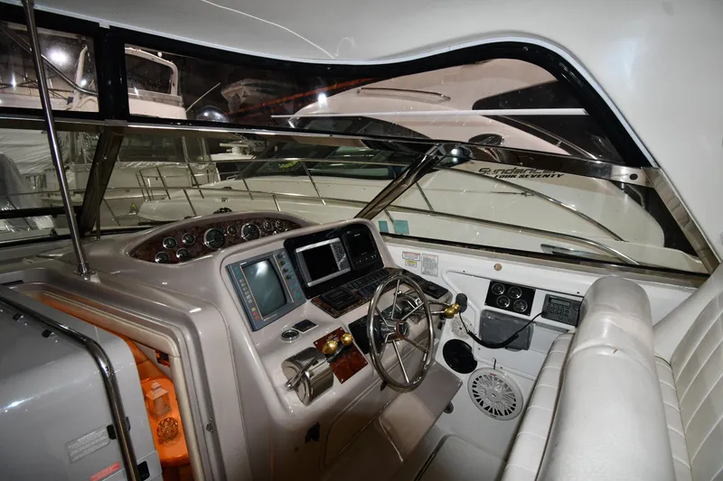 Slide: The Image of Interior cockpit of 2000 Sea Ray 370 Express Cruiser with steering wheel and control panels. - 11