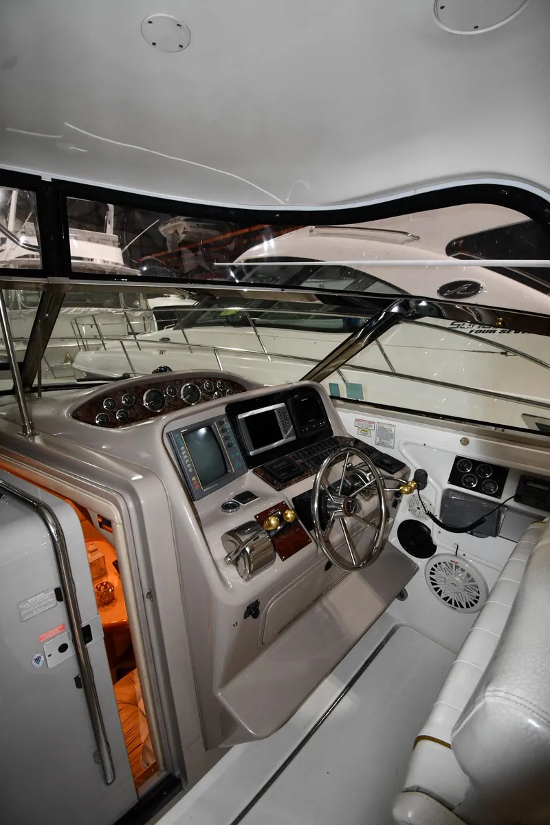 Slide: The Image of 2000 Sea Ray 370 Express Cruiser helm with modern navigation equipment and comfortable seating. - 12