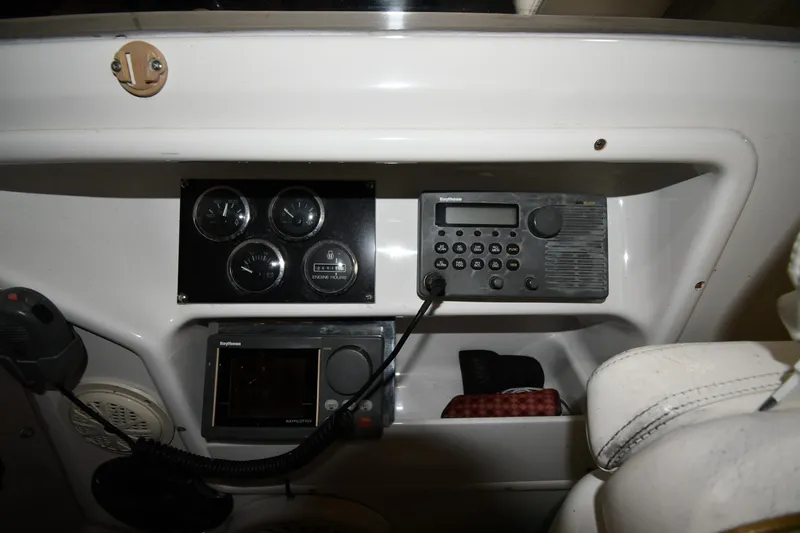 Slide: The Image of Control panel of a 2000 Sea Ray 370 Express Cruiser with gauges and radio equipment. - 13