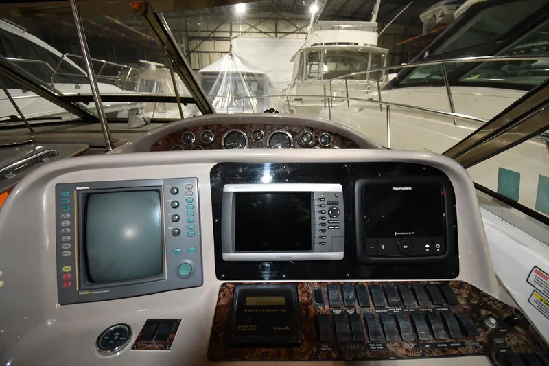 Slide: The Image of Control panel of a 2000 Sea Ray 370 Express Cruiser in a marina setting. - 15