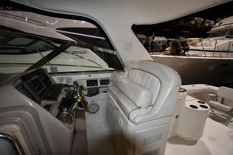 Slide: The Image of 2000 Sea Ray 370 Express Cruiser cockpit with white seating and control panel. - 16