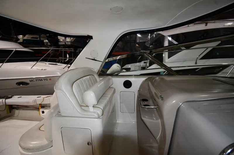 Slide: The Image of 2000 Sea Ray 370 Express Cruiser interior with white seating and sleek design. - 18