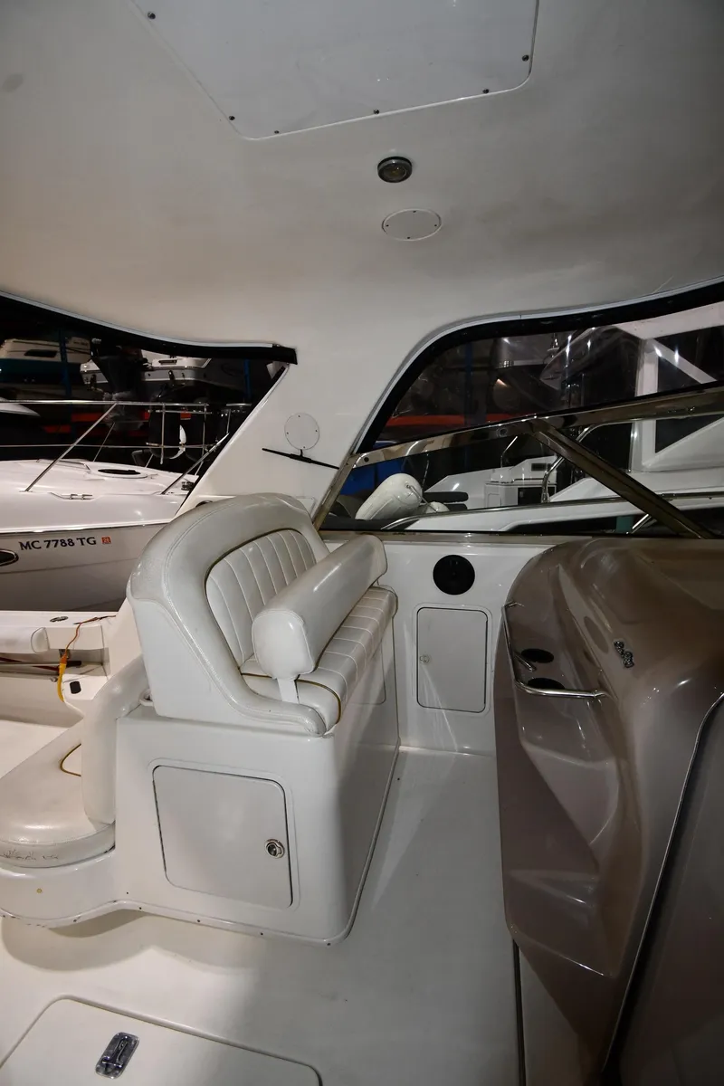 Slide: The Image of 2000 Sea Ray 370 Express Cruiser interior with white seating and helm. - 19