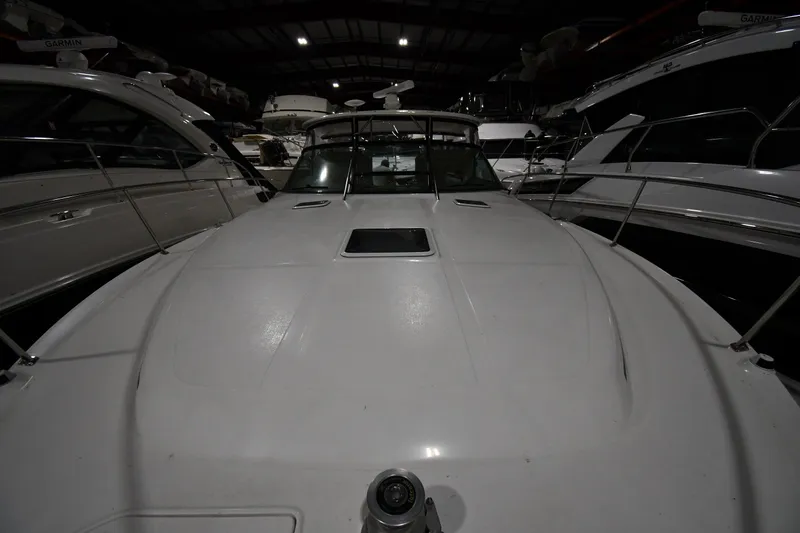 Slide: The Image of 2000 Sea Ray 370 Express Cruiser in a dimly lit storage facility. - 2