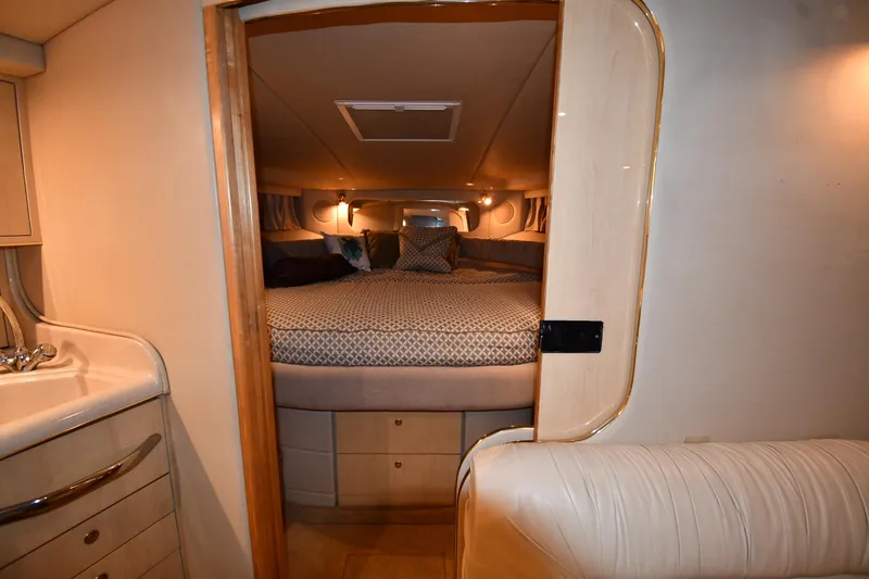 Slide: The Image of Interior cabin of 2000 Sea Ray 370 Express Cruiser with cozy bed and ambient lighting. - 23