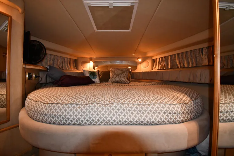 Slide: The Image of Interior cabin of 2000 Sea Ray 370 Express Cruiser with cozy bed and ambient lighting. - 24