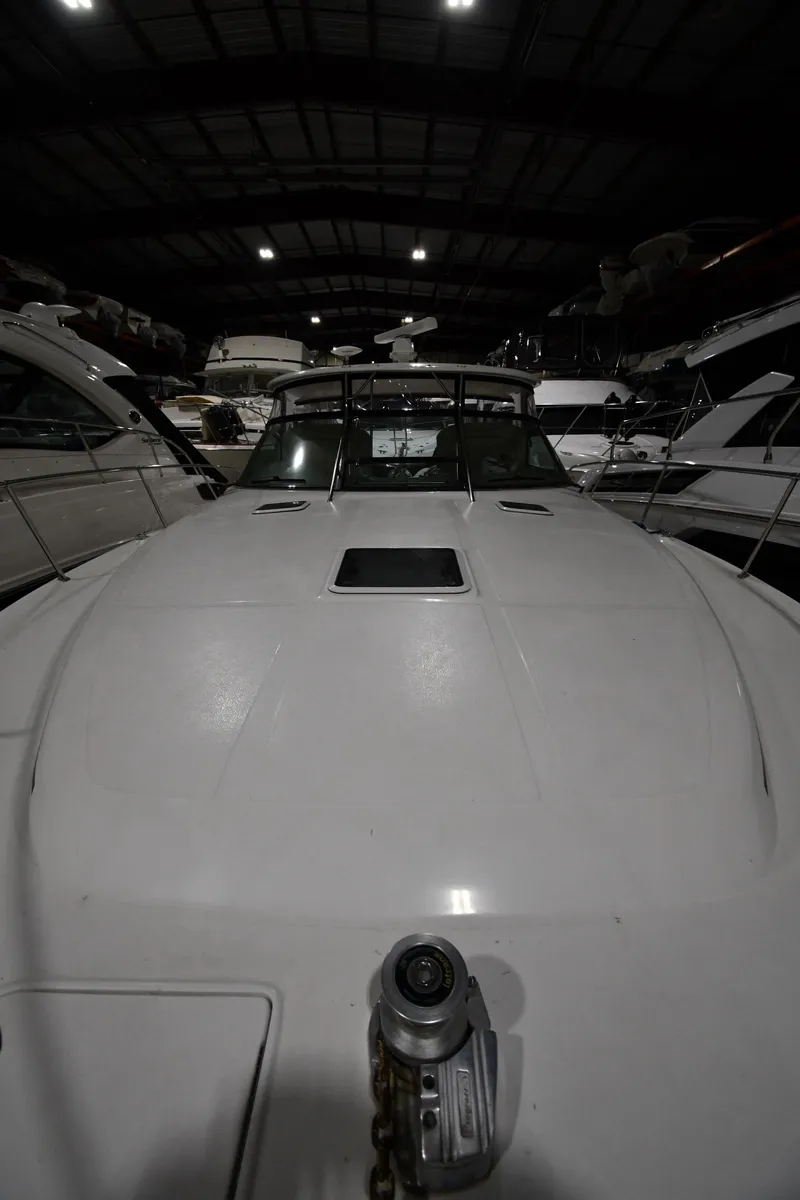 Slide: The Image of 2000 Sea Ray 370 Express Cruiser in a dimly lit indoor storage facility. - 3
