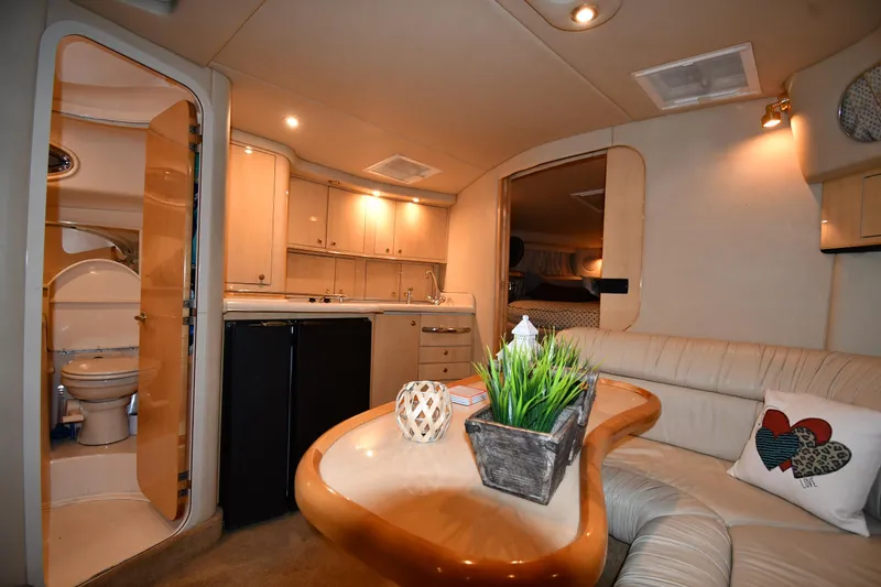 Slide: The Image of Interior of 2000 Sea Ray 370 Express Cruiser with kitchen and seating area. - 31