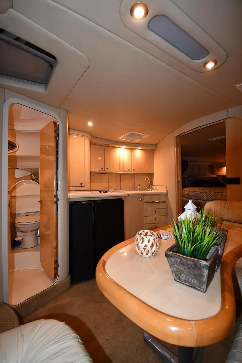Slide: The Image of Interior of 2000 Sea Ray 370 Express Cruiser with kitchenette and seating area. - 32