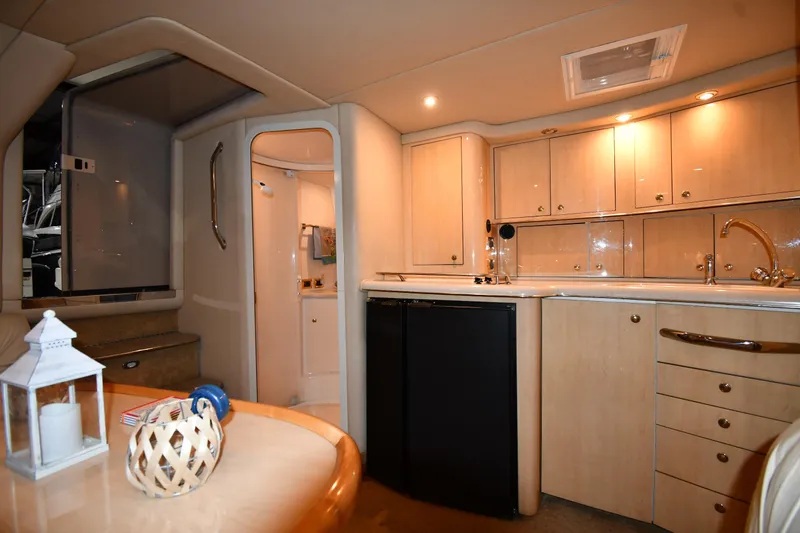 Slide: The Image of Interior of 2000 Sea Ray 370 Express Cruiser with modern kitchen and dining area. - 33