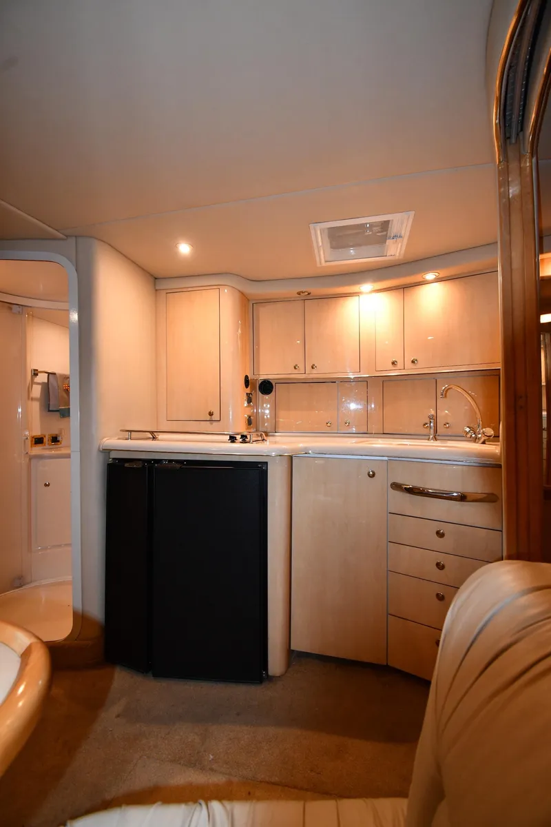 Slide: The Image of 2000 Sea Ray 370 Express Cruiser interior with kitchenette and cabinets. - 34