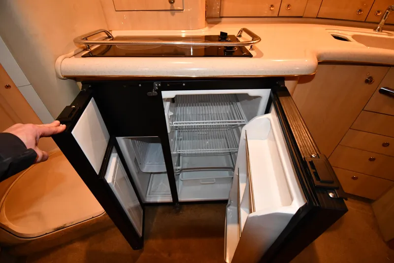 Slide: The Image of 2000 Sea Ray 370 Express Cruiser kitchen with open fridge and countertop. - 39