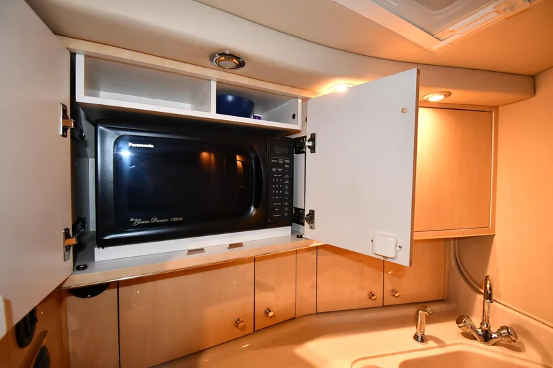 Slide: The Image of 2000 Sea Ray 370 Express Cruiser kitchen with microwave and sink. - 40