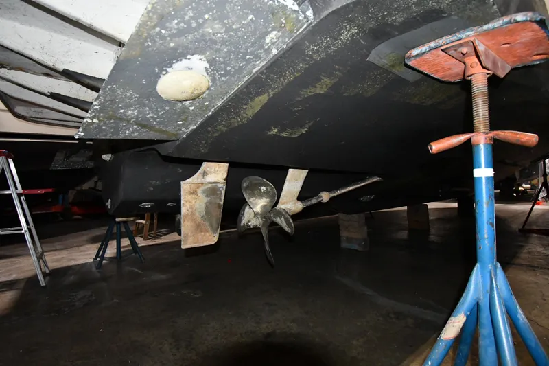 Slide: The Image of Underneath view of a 2000 Sea Ray 370 Express Cruiser on stands in a workshop. - 45
