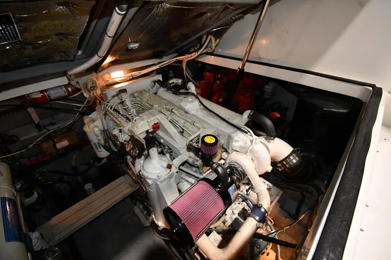 Slide: The Image of Engine compartment of a 2000 Sea Ray 370 Express Cruiser, showcasing detailed mechanical components. - 49