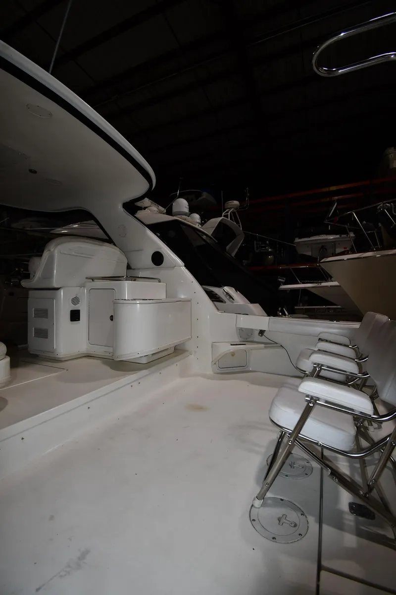 Slide: The Image of 2000 Sea Ray 370 Express Cruiser interior with seating and helm station. - 6