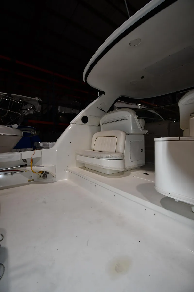 Slide: The Image of 2000 Sea Ray 370 Express Cruiser interior with white seating and helm station. - 8