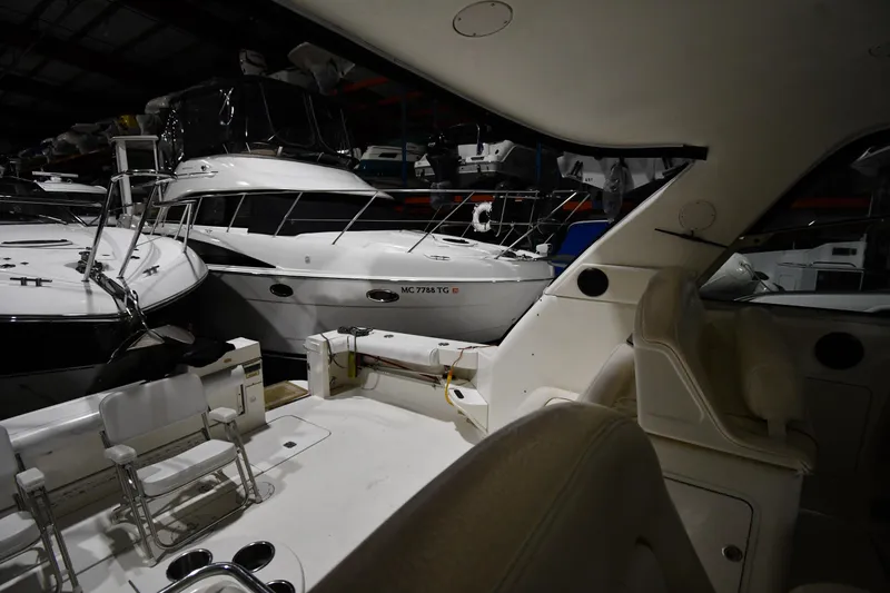 Slide: The Image of 2000 Sea Ray 370 Express Cruiser in a dimly lit indoor storage facility. - 9
