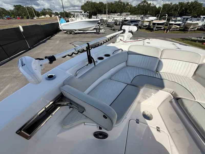 Slide: The Image of 2021 Sea Fox 228 Commander boat with cushioned seating and trolling motor, docked at marina. - 47