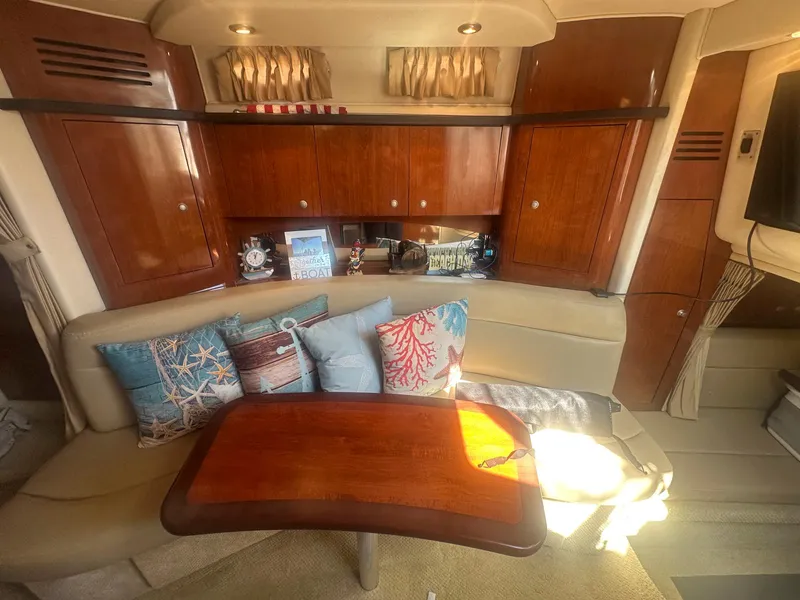 Slide: The Image of Interior of 2007 Sea Ray 320 Sundancer with cozy seating and decorative pillows. - 14