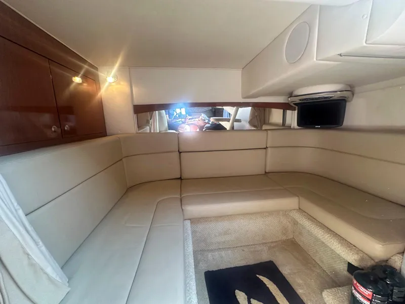 Slide: The Image of Interior of 2007 Sea Ray 320 Sundancer with beige seating and wood accents. - 17