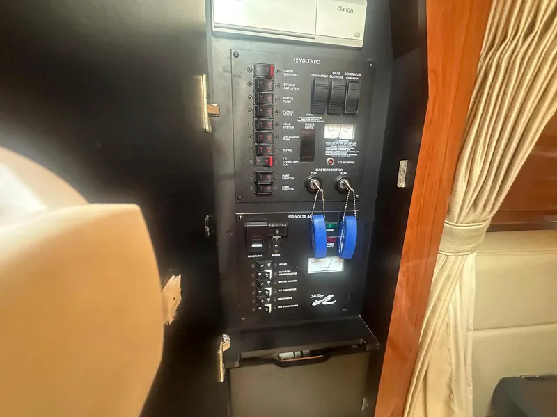 Slide: The Image of Electrical panel inside 2007 Sea Ray 320 Sundancer yacht, featuring switches and controls. - 18