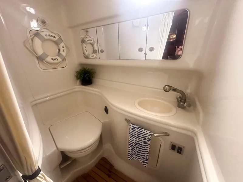 Slide: The Image of 2007 Sea Ray 320 Sundancer bathroom with sink, mirror, and nautical decor. - 19