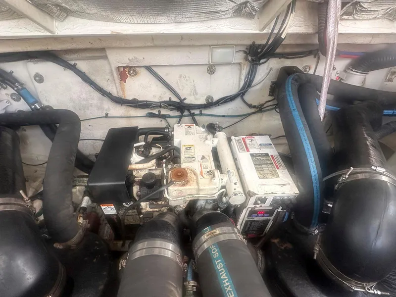 Slide: The Image of Engine compartment of a 2007 Sea Ray 320 Sundancer boat, showing mechanical components. - 21