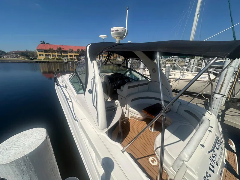 Slide: The Image of 2007 Sea Ray 320 Sundancer docked at marina, featuring sleek design and spacious cockpit. - 3