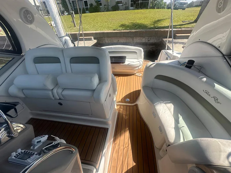 Slide: The Image of 2007 Sea Ray 320 Sundancer interior with white seating and wooden flooring. - 7