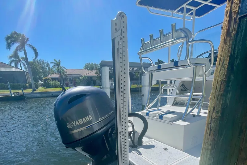 Slide: The Image of 2016 Shallow Sport 18 Sport boat with Yamaha motor docked by waterfront homes. - 11