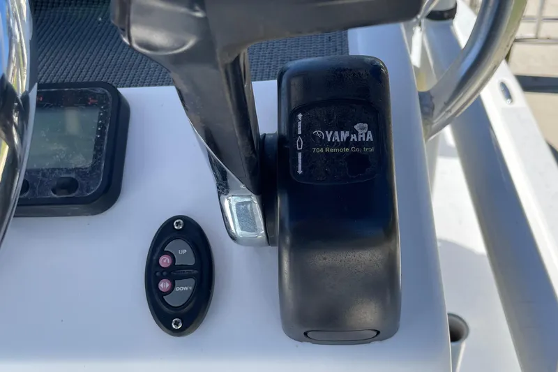 Slide: The Image of Close-up of 2016 Shallow Sport 18 Sport boat controls and throttle. - 12