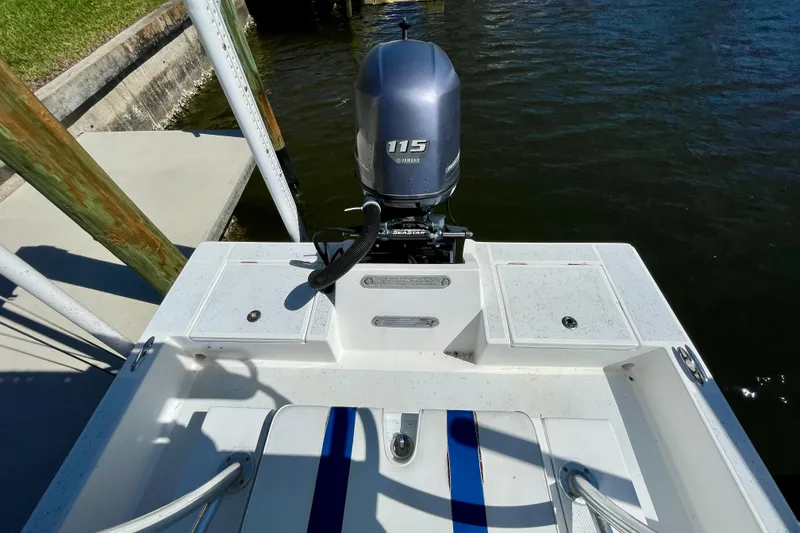 Slide: The Image of 2016 Shallow Sport 18 Sport boat with 115 horsepower outboard motor at dock. - 14