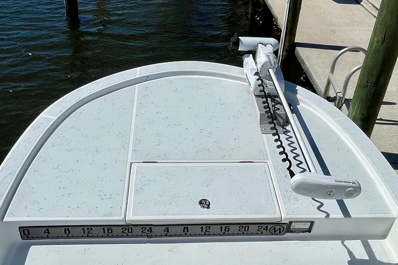 Slide: The Image of 2016 Shallow Sport 18 Sport boat deck with trolling motor and measurement scale. - 15