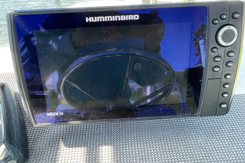 Slide: The Image of Humminbird Helix 10 fish finder on 2016 Shallow Sport 18 Sport boat dashboard. - 16