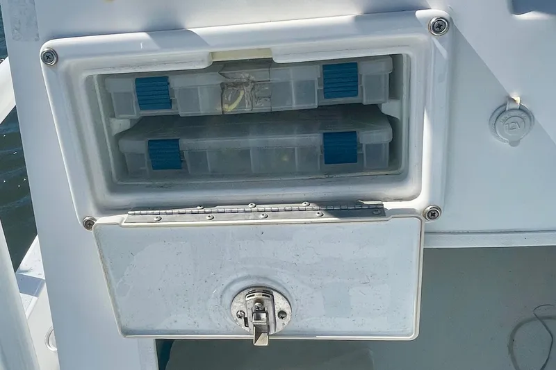 Slide: The Image of Storage compartment on a 2016 Shallow Sport 18 Sport boat with tackle boxes. - 17