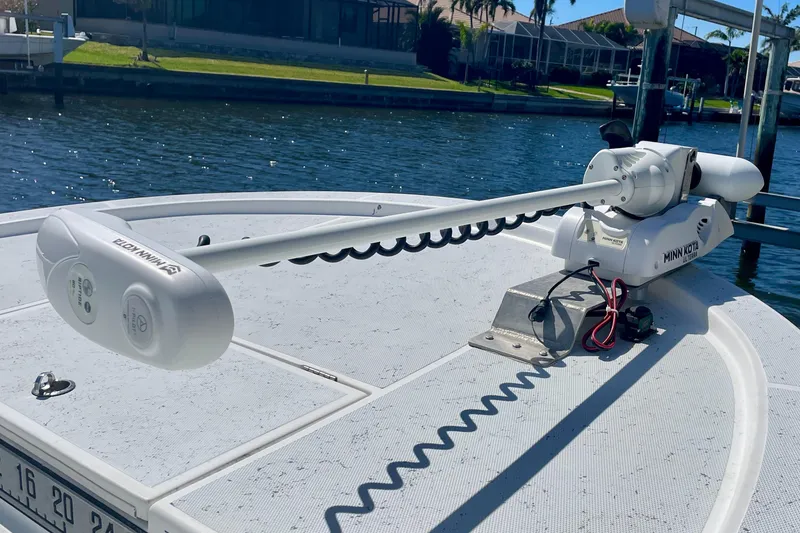 Slide: The Image of 2016 Shallow Sport 18 Sport boat with Minn Kota trolling motor on deck. - 18