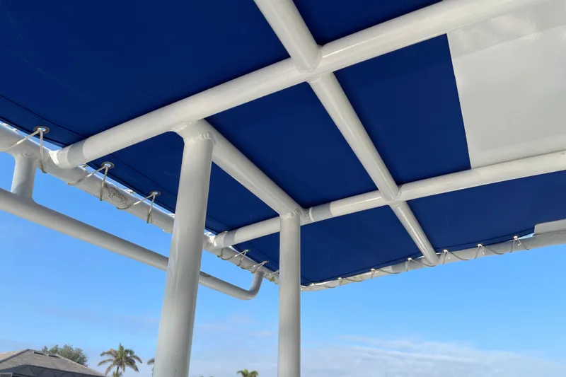 Slide: The Image of 2016 Shallow Sport 18 Sport boat canopy with blue and white design. - 19