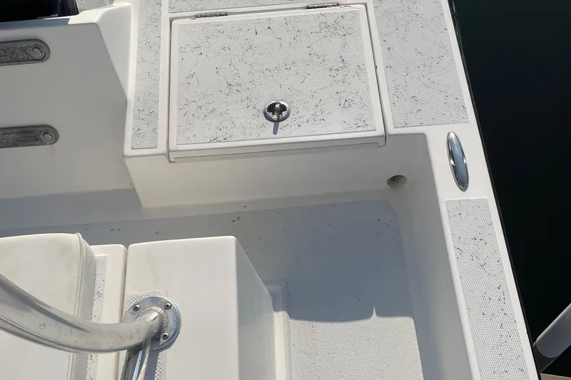 Slide: The Image of 2016 Shallow Sport 18 Sport boat deck with storage compartment and railing. - 20