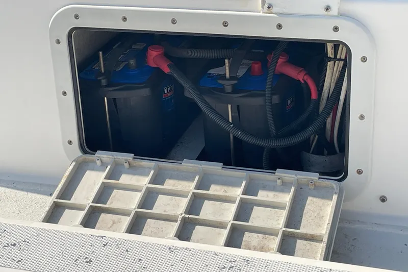 Slide: The Image of Battery compartment of a 2016 Shallow Sport 18 Sport boat, showing two batteries and wiring. - 23