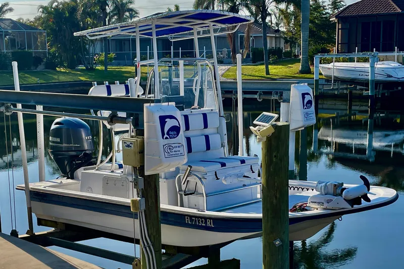 Slide: The Image of 2016 Shallow Sport 18 Sport boat docked in a serene marina setting. - 3