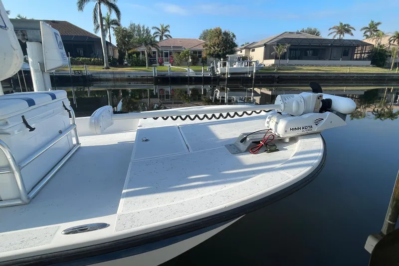 Slide: The Image of 2016 Shallow Sport 18 Sport boat docked by waterfront homes. - 4