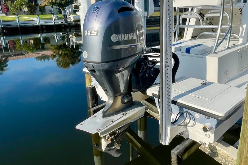 Slide: The Image of 2016 Shallow Sport 18 Sport boat with Yamaha 115 outboard motor docked by the water. - 6