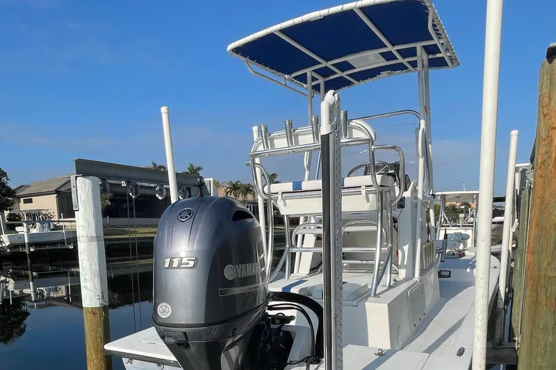 Slide: The Image of 2016 Shallow Sport 18 Sport boat with Yamaha 115 engine docked by waterfront. - 7
