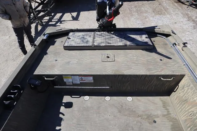 Slide: The Image of 2016 Tracker Grizzly 1860 MVX boat interior with storage compartments and motor mount. - 10