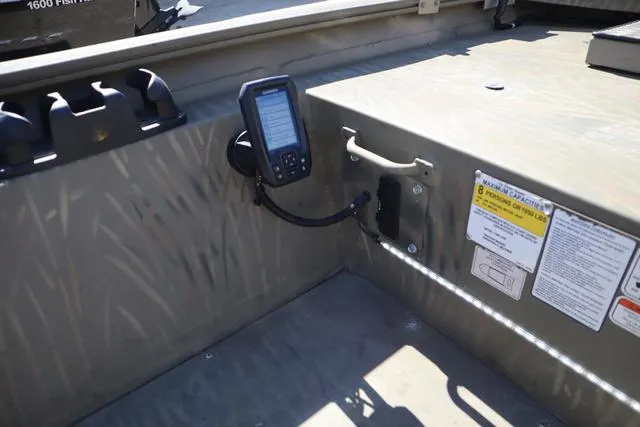 Slide: The Image of 2016 Tracker Grizzly 1860 MVX interior with mounted navigation device and safety instructions. - 11