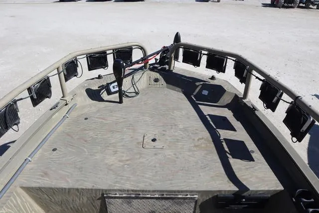 Slide: The Image of 2016 Tracker Grizzly 1860 MVX boat deck with mounted equipment and spacious layout. - 13