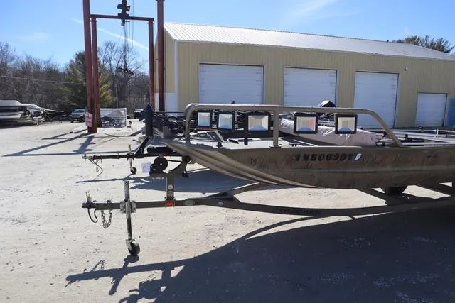 Slide: The Image of 2016 Tracker Grizzly 1860 MVX boat on trailer, parked outdoors near a warehouse. - 4