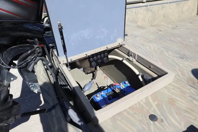 Slide: The Image of 2016 Tracker Grizzly 1860 MVX boat battery compartment with wiring and connections. - 5