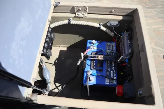 Slide: The Image of Battery compartment of 2016 Tracker Grizzly 1860 MVX boat, showing wiring and connections. - 8